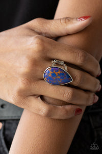 Stormy Sunrise - Purple Ring - Paparazzi Accessories A generous polished blue stone infused with veins of brown and purple is encased in a simple silver teardrop frame resulting in a seasonal finish atop the finger. Features a stretchy band for a flexible fit.  Sold as one individual ring.