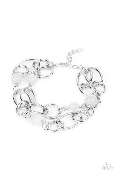 Delightfully Daydreamy - White Bracelet - Paparazzi Accessories Chunky silver links and glassy white cat's eye stone beads join into two dreamy layers around the wrist, creating a whimsical centerpiece. Features an adjustable clasp closure.  Sold as one individual bracelet.  New Kit