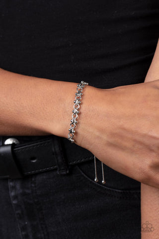 Slide On Over - Silver Pull Cord Bracelet - Paparazzi Accessories A dainty section of silver beaded fittings and silver links delicately attaches to a rounded silver snake chain around the wrist, creating a sleek metallic shimmer. Features an adjustable sliding bead closure.  Sold as one individual bracelet.  New Kit