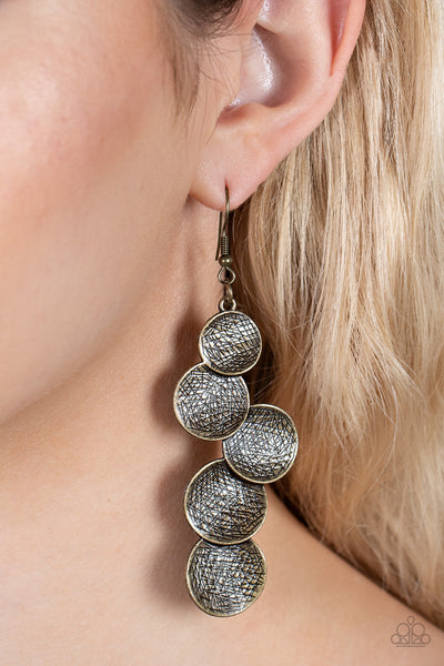 Token Gesture - Brass Earrings - Paparazzi Accessories Scratched in edgy shimmer, beveled brass discs gradually increase in size as they overlap into a demanding display. Earring attaches to a standard fishhook fitting.  Sold as one pair of earrings.