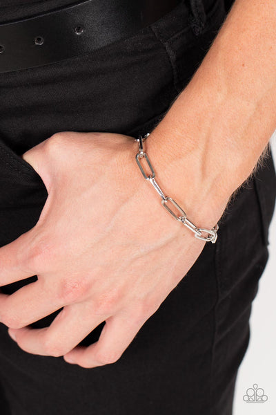 Tailgate Party - Silver Bracelet - Paparazzi Accessories An oversized collection of silver oblong links interlock around the wrist for a casual hint of shimmer. Features an adjustable clasp closure.  Sold as one individual bracelet.  New Kit