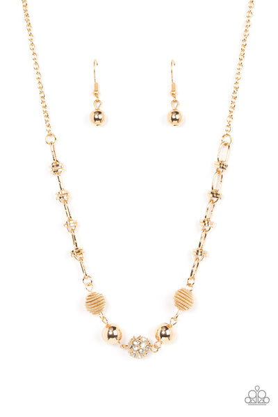 Taunting Twinkle - Gold Necklace - Paparazzi Accessories Pairs of gold coiled and smooth gold beads flank a white rhinestone encrusted bead along an oval and gold disc linked chain, creating a glitzy combination below the collar. Features an adjustable clasp closure.  Sold as one individual necklace. Includes one pair of matching earrings.  New Kit