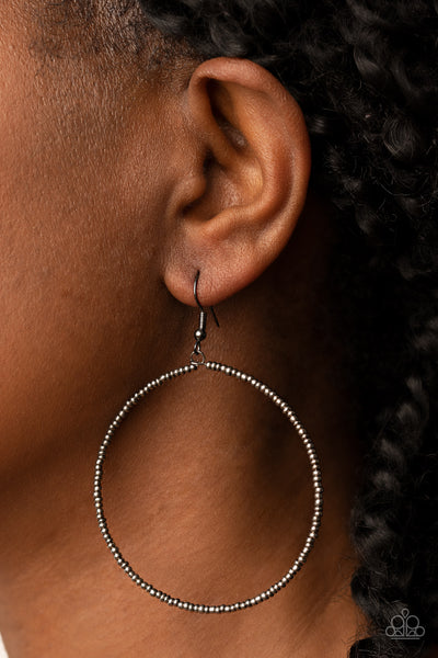 Basically Beaded - Black Earrings - Paparazzi Accessories Dainty gunmetal seed beads are delicately threaded along a gunmetal wire hoop, creating a causal pop of metallic shimmer. Earring attaches to a standard fishhook fitting.  Sold as one pair of earrings.  New Kit