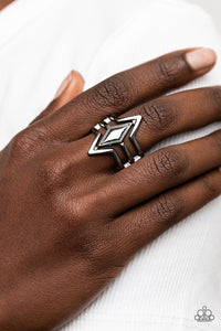 Deceivingly Diamond - Black Ring - Paparazzi Accessories Gunmetal bands angle around a gunmetal diamond shaped frame, layering into a deceivingly simple centerpiece atop the finger. Features a stretchy band for a flexible fit.  Sold as one individual ring.