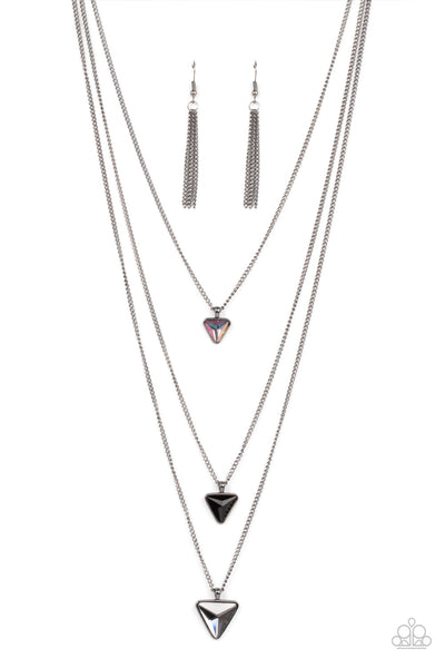 Follow the LUSTER - Black Necklace - Paparazzi Accessories Glassy iridescent, black, and smoky triangular gems gradually increase in size as they swing from the bottoms of extended gunmetal chains, layering into an edgy shimmer across the chest. Features an adjustable clasp closure.  Sold as one individual necklace. Includes one pair of matching earrings.