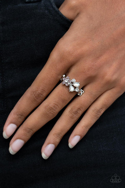 Enchanting Efflorescence - Purple Ring - Paparazzi Accessories A purple rhinestone dotted floral frame joins round and teardrop white rhinestones atop a dainty silver band, blooming into an enchanting centerpiece across the finger. Features a dainty stretchy band for a flexible fit.  Sold as one individual ring.