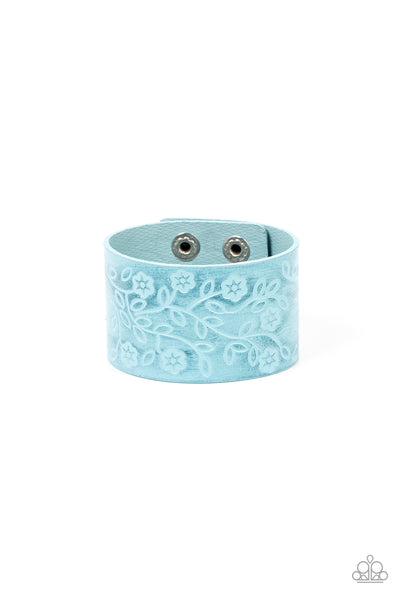 Rosy Wrap Up - Blue Bracelet - Paparazzi Accessories A flowery and leafy motif blooms across the front of a distressed blue leather band, resulting in a rustic floral centerpiece around the wrist. Features an adjustable snap closure.  Sold as one individual bracelet.  New Kit