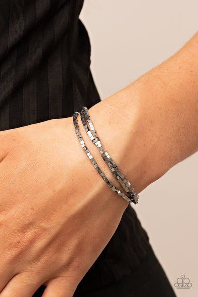 Block Bash - Silver Stretch Bracelets - Paparazzi Accessories A dainty collection of silver cube beads alternates along stretchy bands, stacking into edgy layers around the wrist.  Sold as one set of three bracelets.