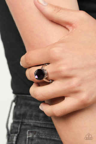 Updated Dazzle - Purple Ring - Paparazzi Accessories A stunning faceted plum gem, set in edgy pronged fittings, creates a glamorous show-stopping centerpiece atop sleek silver bands. Features a dainty stretchy band for a flexible fit.  Sold as one individual ring.