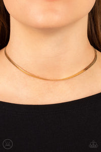 In No Time Flat - Gold Choker Necklace - Paparazzi Accessories A strand of glistening gold snake chain loops around the neck, resulting in an edgy shimmer. Features an adjustable clasp closure.  Sold as one individual choker necklace. Includes one pair of matching earrings.  New Kit Choker