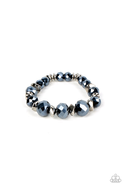 Astral Auras - Blue Bracelet - Paparazzi Accessories Separated by silver discs and faceted silver accents, faceted blue crystal-like gems are threaded along stretchy bands around the wrist for a stellar statement.  Sold as one individual bracelet.   Get The Complete Look! Necklace: "Cosmic Cadence - Blue" (Sold Separately)  New Kit