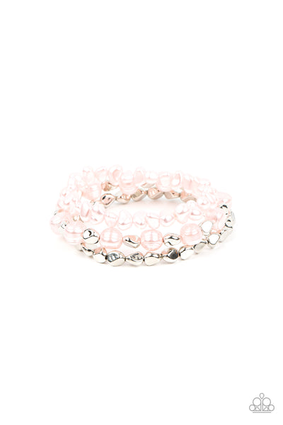 Shoreside Soiree - Pink Stretch Bracelet - Paparazzi Accessories Etched in natural inspired texture, oversized Gossamer Pink pearls alternate with faceted silver beads along a stretchy band around the wrist. The imperfect pearl centerpiece layers with a pair of faceted silver and Gossamer Pink pebble-like pearls, resulting in timeless layers.  Sold as one set of three bracelets.  New Kit