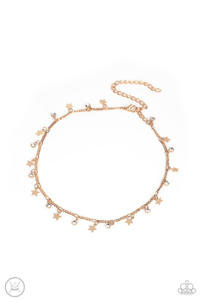 Little Lady Liberty - Gold Choker Necklace - Paparazzi Accessories Dainty white rhinestones and flat gold stars twinkle along a classic gold chain around the neck, resulting in a stellar fringe. Features an adjustable clasp closure.  Sold as one individual choker necklace. Includes one pair of matching earrings.  New Kit Choker